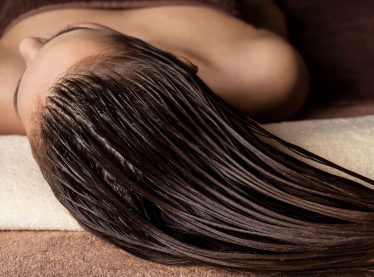 close-up of top of person's head, hair wet and combed, lying down, wearing towel Text on Image: Head Spa, Scalp therapy for hair health & relaxation