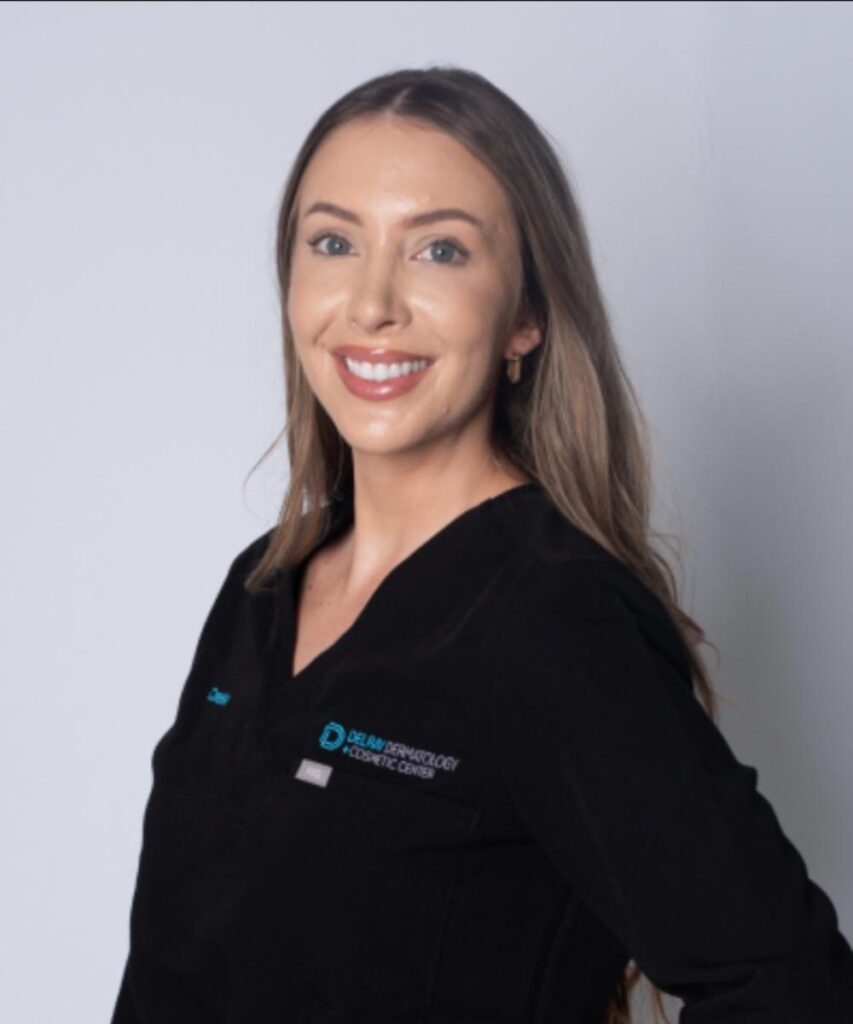 Cassie Hoyt, CME, smiling, wearing black scrub top